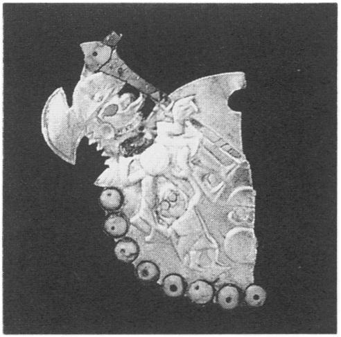 Figure 30. Nose ornament, Moche, from Sipan, Peru, Early Intermediate Period. Silver and gold, W. 8.5 cm.