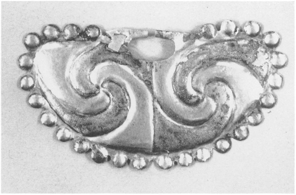 Wypyski) B Figure 51. Nose ornament, Moche, Peru. Partially silvered gold sheet, W. 6.7 cm. Alternating swirls of unsilvered and silvered gold sheet.