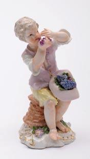72 72. A pair of Meissen figures of a recumbent ram and ewe on oval bases with flowers and foliage, 8 cm and 7.