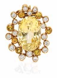 167 168 167 An 18 Karat Yellow Gold, Yellow Sapphire and Diamond Ring, David Webb, in a hammered inish setting containing one oval shape mixed cut yellow sapphire weighing approximately 39.
