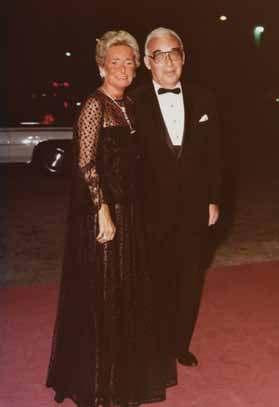 The Hassenfelds dressed for an opening night gala in the 1980s. Mrs. Hassenfeld wears her Cartier Art Deco emerald and diamond lapel watch and necklace.