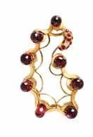 $500-700 195 A Pair of 14 Karat Yellow Gold and Ruby Earclips, containing two oval shape cabochon cut rubies measuring approximately 15.
