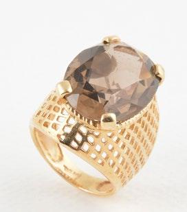 1229 AND STONE 14K yellow gold ring set with a cabochon of oval stone (probably tiger s eye).