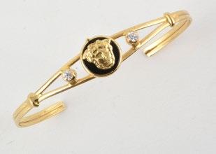 1026 18K yellow gold rigid bracelet decorated with a face within a medallion and set with two (2) small
