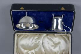 Lot 87 Lot 87 A CASED GEORGE V SILVER CREAM JUG AND SUGAR BOWL SET, pie crust edge, three cabriole legs, makers E.S. Barnsley & Co, Birmingham 1919, approximately 3.