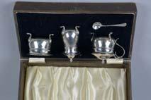 1ozt, 65 grams (3) 80-120 plus BP* Lot 112 Lot 112 A CASED GEORGE VI SILVER CONDIMENT SET, wavy rims over circular bodies, on three cabriole legs with pad feet, with one spoon and one missing,