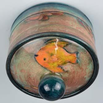 Lot 204 A WILLIAM MOORCROFT FLAMBE JAR AND COVER, of circular form, (probably a humidor), spherical finial, cover with fish and seaweed, the base with a continuous band of seaweed,