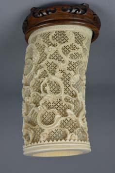 CENTURY IVORY BRUSH POT, with carved decoration of dragons on an intricately pierced ground of interlinked circles, height approximately 22cm, on a carved