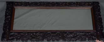 Lot 414 Lot 414 A LATE 19TH CENTURY CARVED OAK FRAMED MIRROR, of rectangular form, with foliate scrolls, exotic