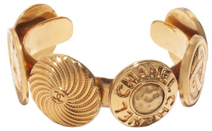 gold-toned cuff with coin designs.