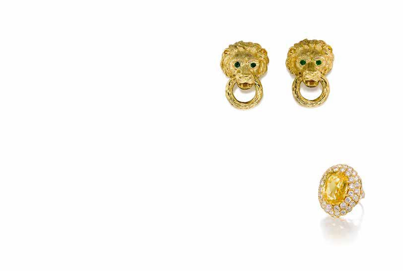 97 $4,000-6,000 98 A PAIR 18K GOLD AND EMERALD EAR CLIPS, VAN CLEEF & ARPELS designed as sculpted lion heads, suspending a textured ring, enhanced by two emerald eyes; signed VCA, no.