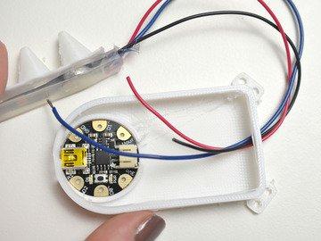Route your NeoPixel strip's wires through the hole at the top of the