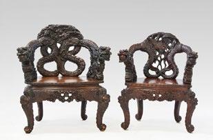 Rare pair of Monsieur / Madame richly carved wood armchairs: the armrests of the Monsieur armchair each adorned with a dragon above agitated waves, holding