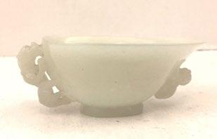 5 134B, QING DYNASTY Greenish white jade cup carved two Fo dogs.