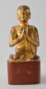 Silver Buddha standing in his monastic robe, wearing a ushnisha adorned with a
