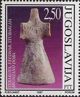 Her breasts and belly are small in comparison to her enormous hips and legs. A stamp from Yugoslavia in Figure 7 (Scott 2392), issued in 1977, shows a long skirted female terra cotta figurine.