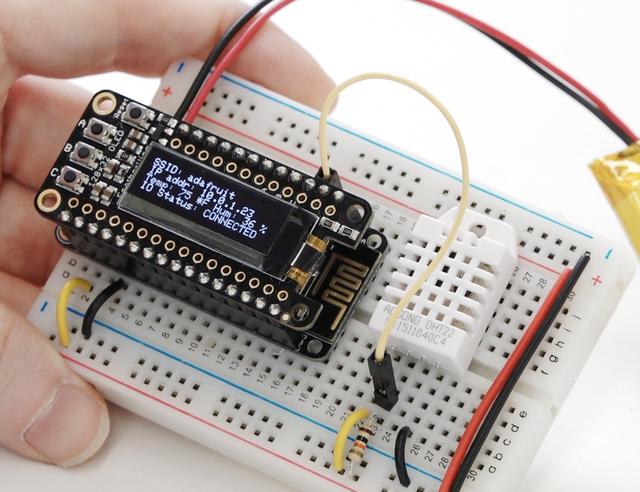 Add an OLED Now that you've got a graphing weather device using IO, you can add an OLED feather so you can see network status, IP address, and the latest measurements!