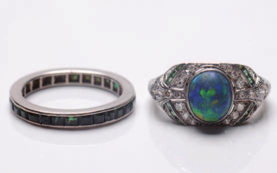 148 148. An early 20th Century black opal, emerald and diamond cluster ring the central oval black opal approximately 8.3mm x 6.