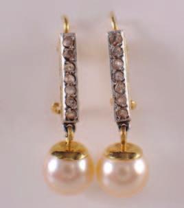 a single cultured pearl suspended from a line of rose diamonds and