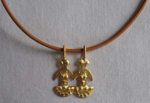 The charms hang on a brown leather cord, other colors are available upon request.