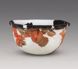 The sandy pottery is usually red outside and black inside, and the color is uneven and the body thick. The fine clay ware is chiefly red both in slip and in body and coated with red color.