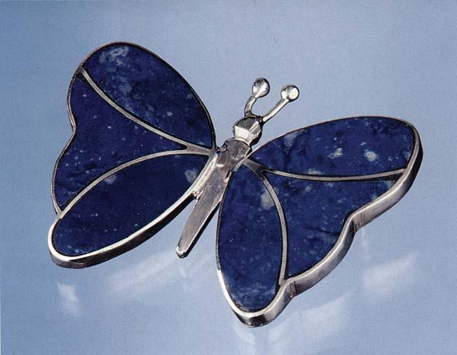 Figure 1. Chilean lapis lazuli is currently used in a variety of ways, but the finer-quality material is incorporated into jewelry. This sterling silver brooch (3.8 2.