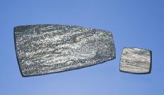 Figure 8. Tablets of specular hematite (left) and drusy hematite (right) from Arizona were among the unusual gem materials seen at Tucson this year. The large piece measures 53.4 28.0 4.
