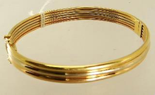 Lot # 438 Lot # 451 438 18k yellow tri gold hinged bracelet.