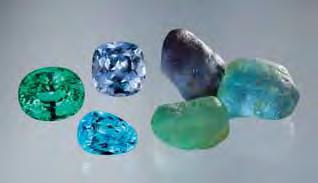 Figure 19. Mozambique Cu-bearing tourmaline pebbles commonly are of a single color, yielding cut stones with even color distribution (here, 6.75 15.77 ct). All but the blue faceted stone are unheated.