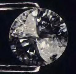 Figure 16. Introduction of a glass filler into this 0.30 ct diamond s cleavage cracks produced a dramatic change in apparent clarity (before filling, left; after filling, right).