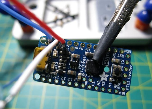 Connect these three wires to their designated pins on the Pro Trinket Backpack, and solder a bridge for the +500 mah
