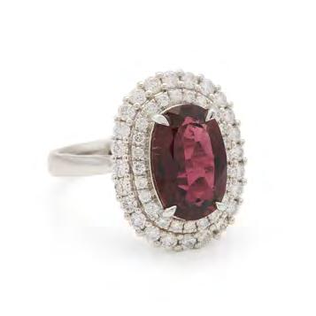 91 18K WHITE GOLD RING set with an oval cut rubellite (approx. 2.70ct.) encircled by 48 small brilliant cut diamonds, size 6 1/2, 5.