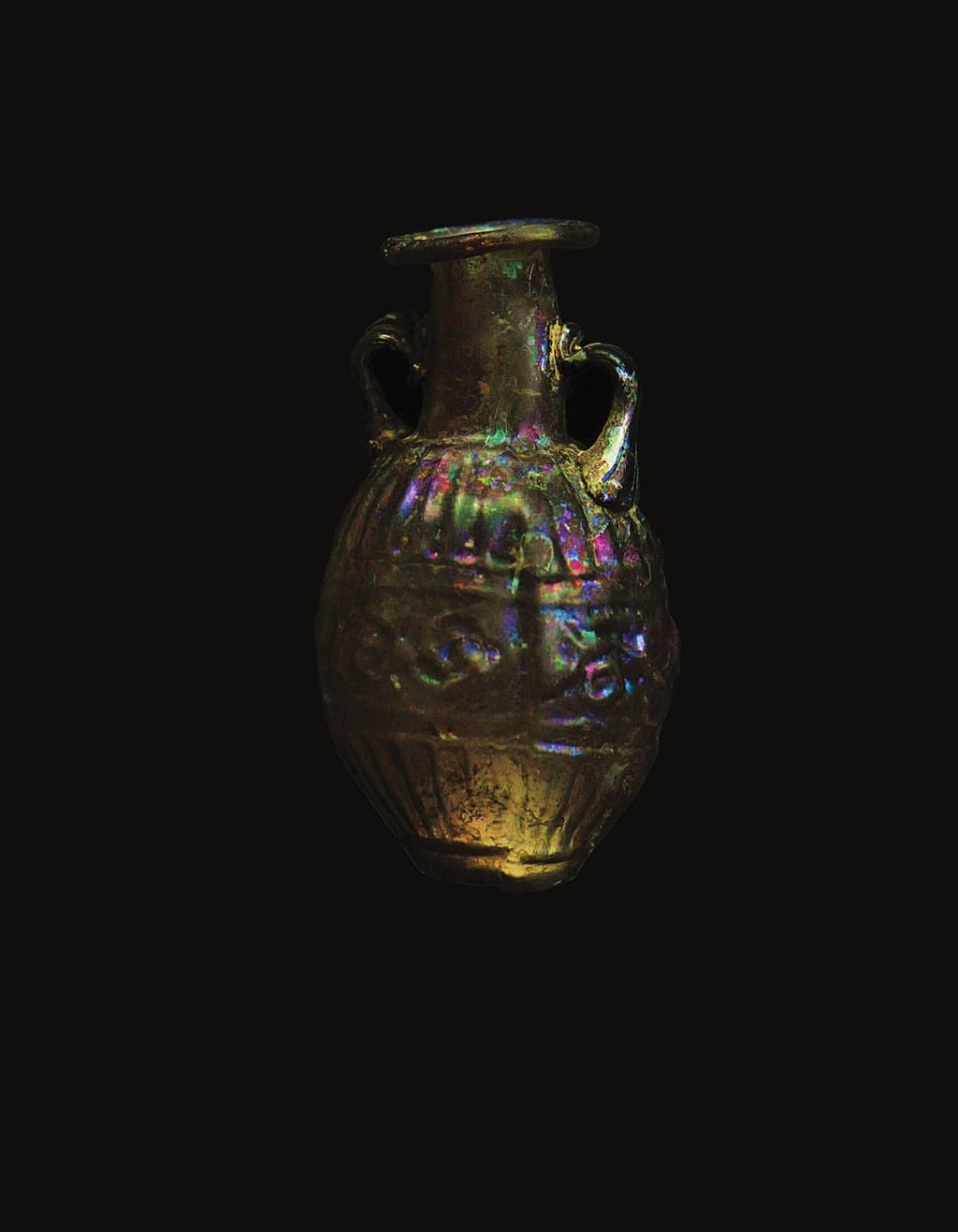 ANCIENT GLASS SIDONIAN GLASS VASE WITH SCROLL PATTERN Light aubergine in color, with ovoid body of this vessel being blown in a two-part mold.
