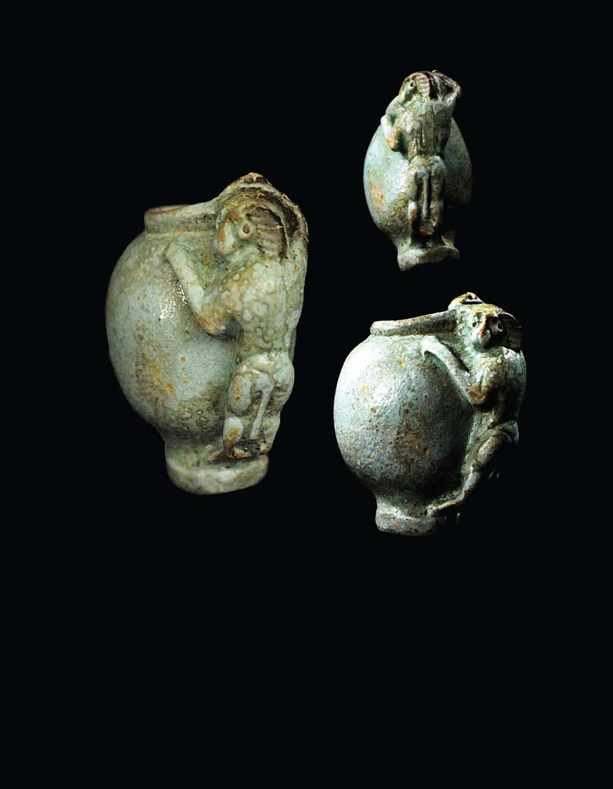 EGYPTIAN EGYPTIAN FAIENCE GROUP OF A MONKEY AND A JAR Monkeys amused the ancient Egyptians, who often kept them as pets, and throughout Egyptian history, they were enjoyed for their playful and