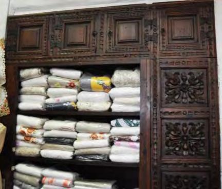 The display cupboard for linen was made of beautiful carved wood.