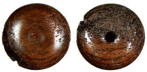 Two netsuke were also found in the tomb. Fig. 22: A manju netsuke of dark wood, described in the report as lacquered, but nevertheless partially decayed.
