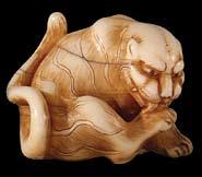 Lot 159, finely carved and functionally designed with head bent back and legs folded beneath for compactness, this wonderful ivory example of an 18th century Kyoto school long-haired dog was a little