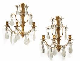 162 a pair of baroque style rock crystal and brass three light wall lights. c. 1900. H 38 cm.
