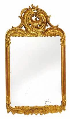 167 a south German rococo giltwood mirror, carved with openwork rocailles and foliage, beveled mirror glass. Mid 18th century. H. 133 cm. W.