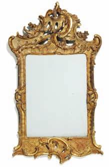 195 195 a north German rococo giltwood mirror, carved with openwork c-scrolls, rocailles and flower heads. Mid 18th century. H. 90 cm. W. 53 cm.