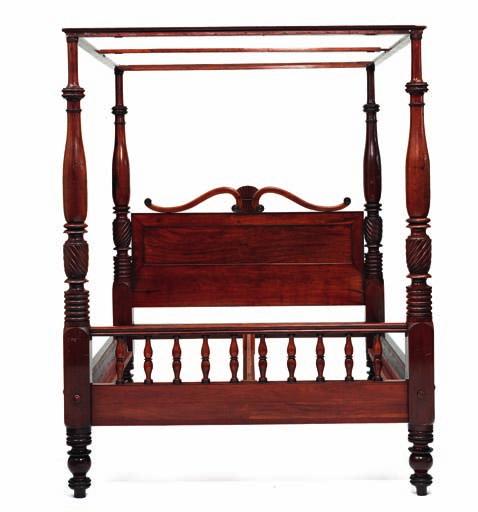 259 259 a danish West indian four-poster mahogany bed, the four posters carved with twisted profiles, curved headboard with rosettes, footboard with turned rods. Mid 19th century. H. 233 cm. l.