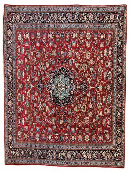 298 298 a Keshan, persia. classical medallion design on a red field of rosettes, flowers and foliage. Knotted with kork wool and highlights with silk pile.
