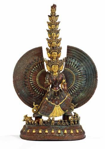 327 Buddhist part gilt large copper figure of avalokiteshvara with numerous arms and 19 heads, standing on a base with boddhisatvas and animals. 20th century. H. 120 cm.