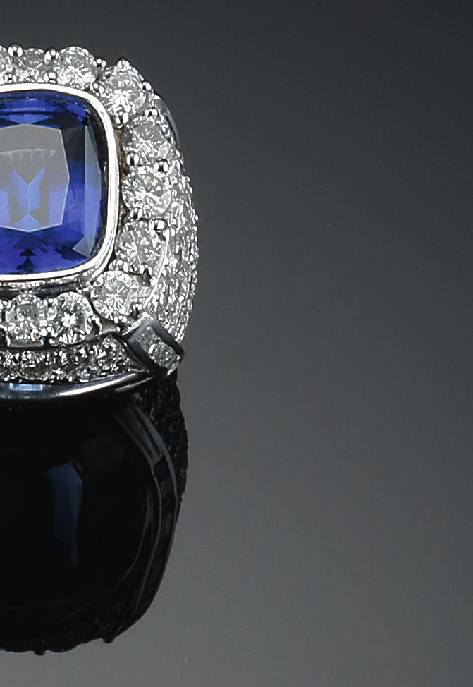 518 a tanzanite and diamond ring set with a cushioncut tanzanite weighing app. 13.00 ct. and numerous brilliant-cut diamonds weiging a total of app. 11.30 ct., mounted in 18k white gold. size 66.5. weight 58 gr.