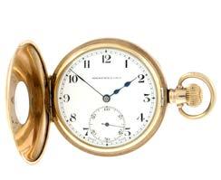 50-80 274 A half hunter pocket watch. Gold plated case with engraved cuvette. Keyless wind fifteen jewel movement with club tooth lever escapement signed Angus. White dial. 50mm.