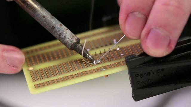 After placing a component on the board, bend its leads outward to keep it in place while soldering. IC pins are much shorter - but the same technique works for them as well.