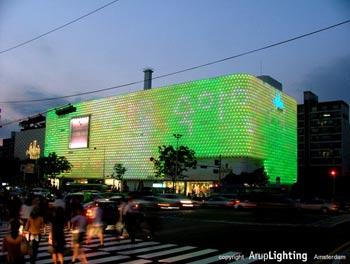 a building wrapped in LED lights that, during day has