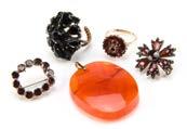 494. Five Victorian and later items of jewellery, including a Maltese cross style garnet brooch, a