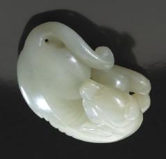 25"H, Circa - 18th - 94 Chinese Qing carved jade pendant depicting a recumbent dog. 1"H x 2"W x 1.375"D, Circa - 18th - 2,000.00-2,500.