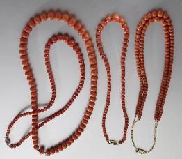 144 (4) Chinese carved red coral necklaces with gold clasps. 155.9 grams, total.